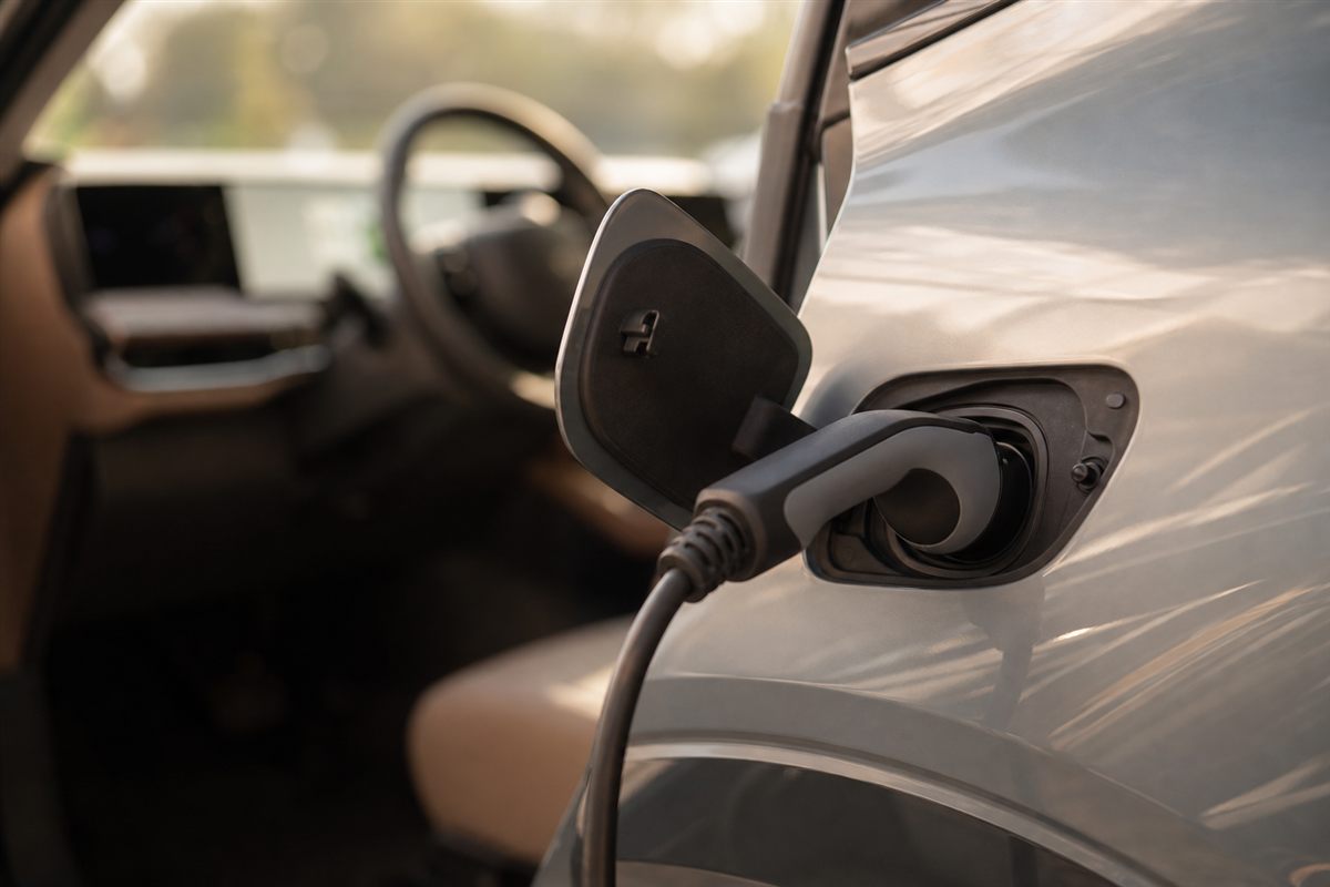 Electric vehicle charging cable plugged into a car charge port